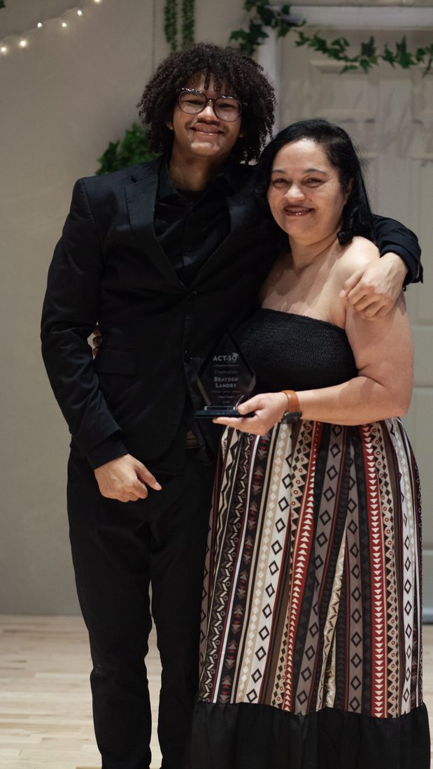 Brayden Landry celebrating his ACT-SO Dramatics award with family